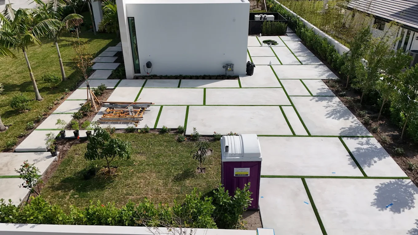 Large-format concrete pavers with turf joints in modern courtyard