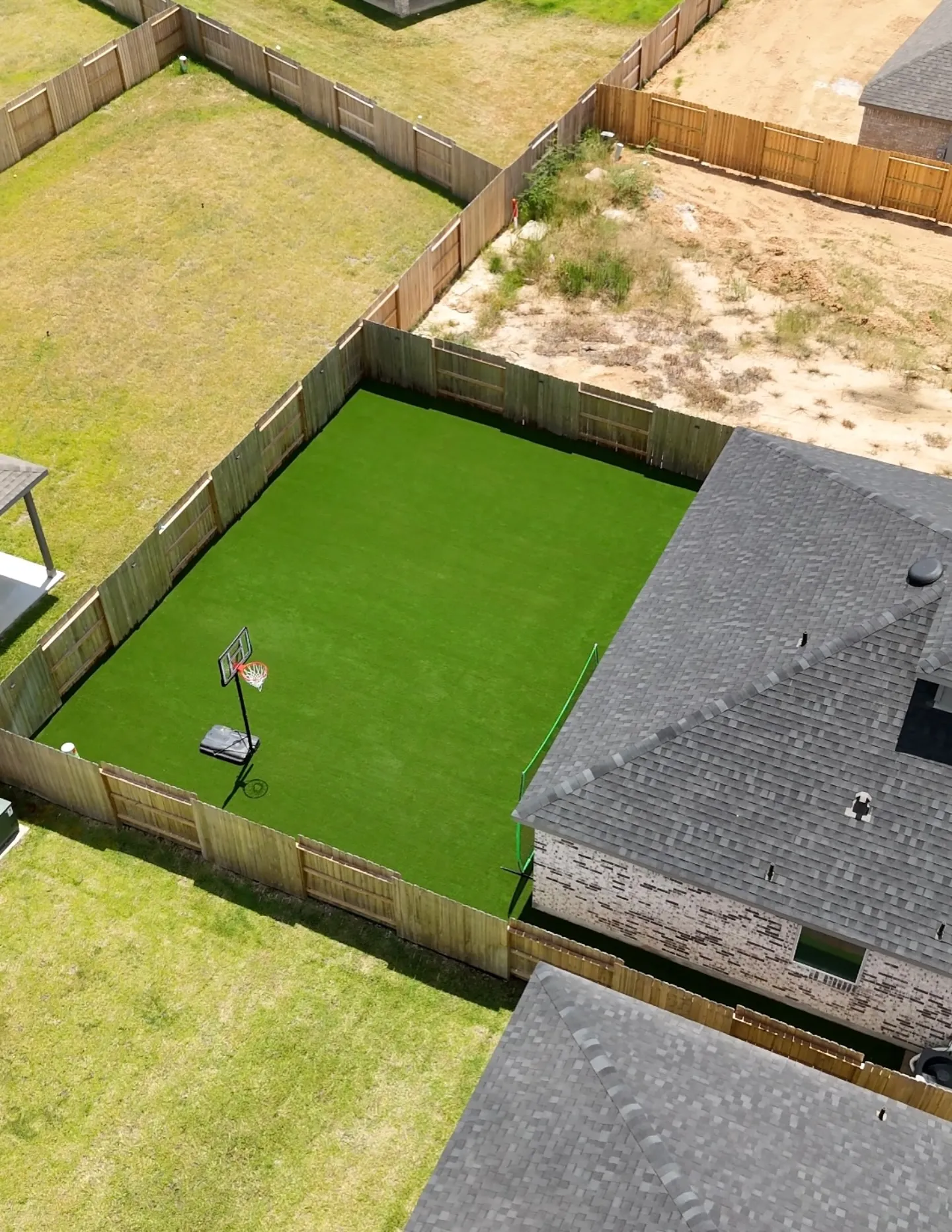 Full backyard artificial turf install with basketball hoop