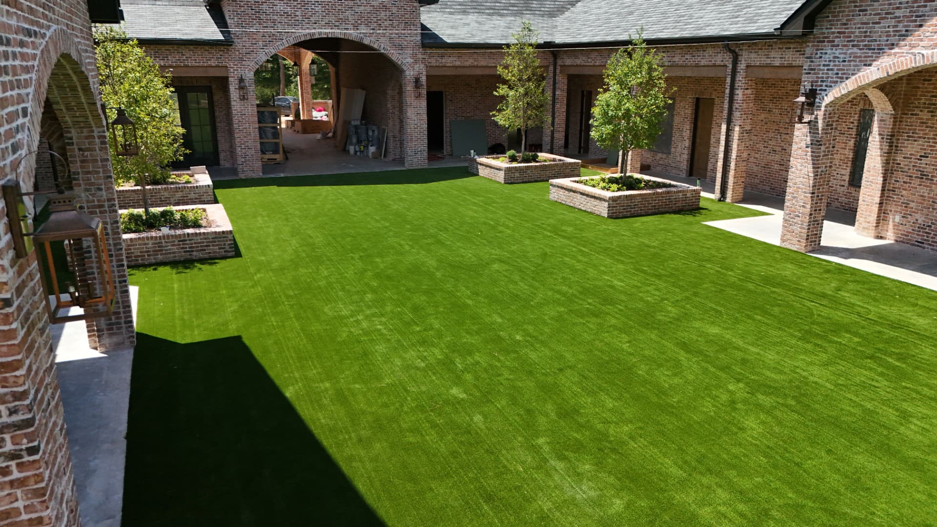 Commercial event venue courtyard finished with premium artificial turf near Houston