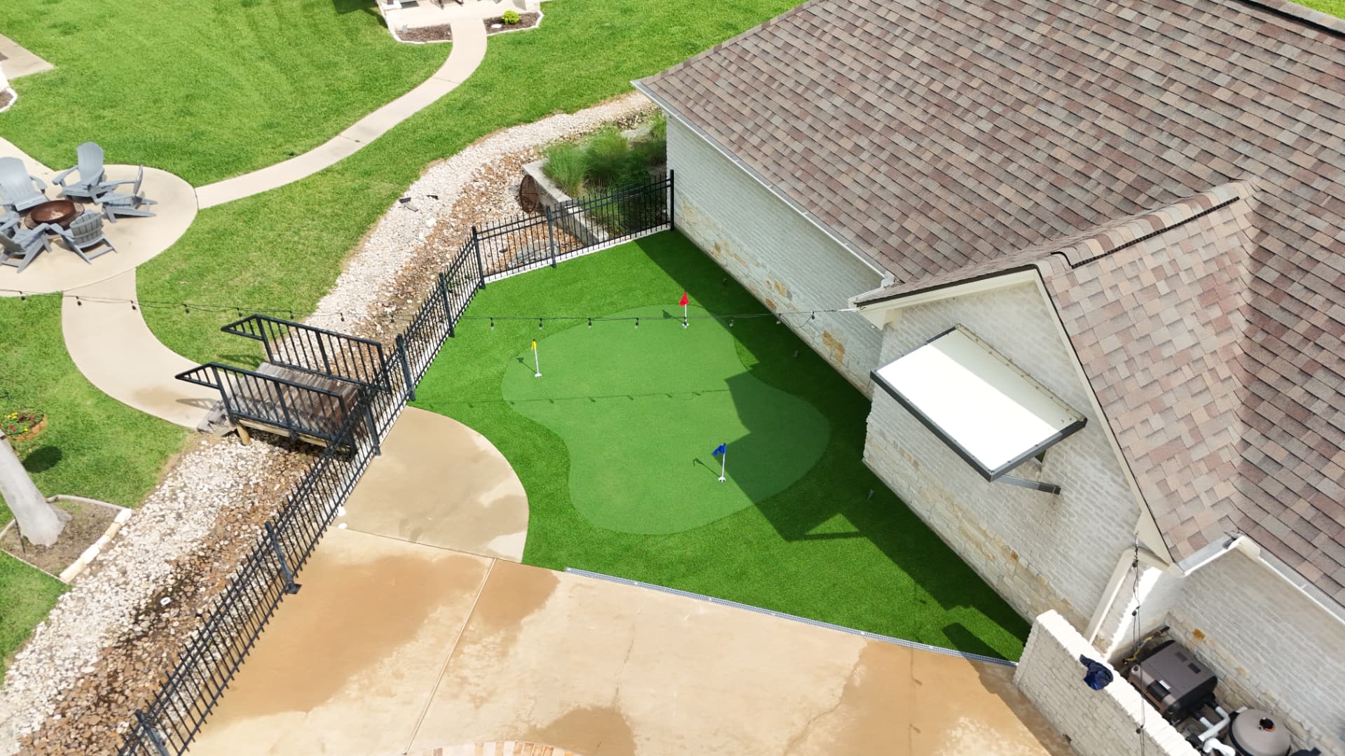 Contoured backyard putting green with turf surround in Houston